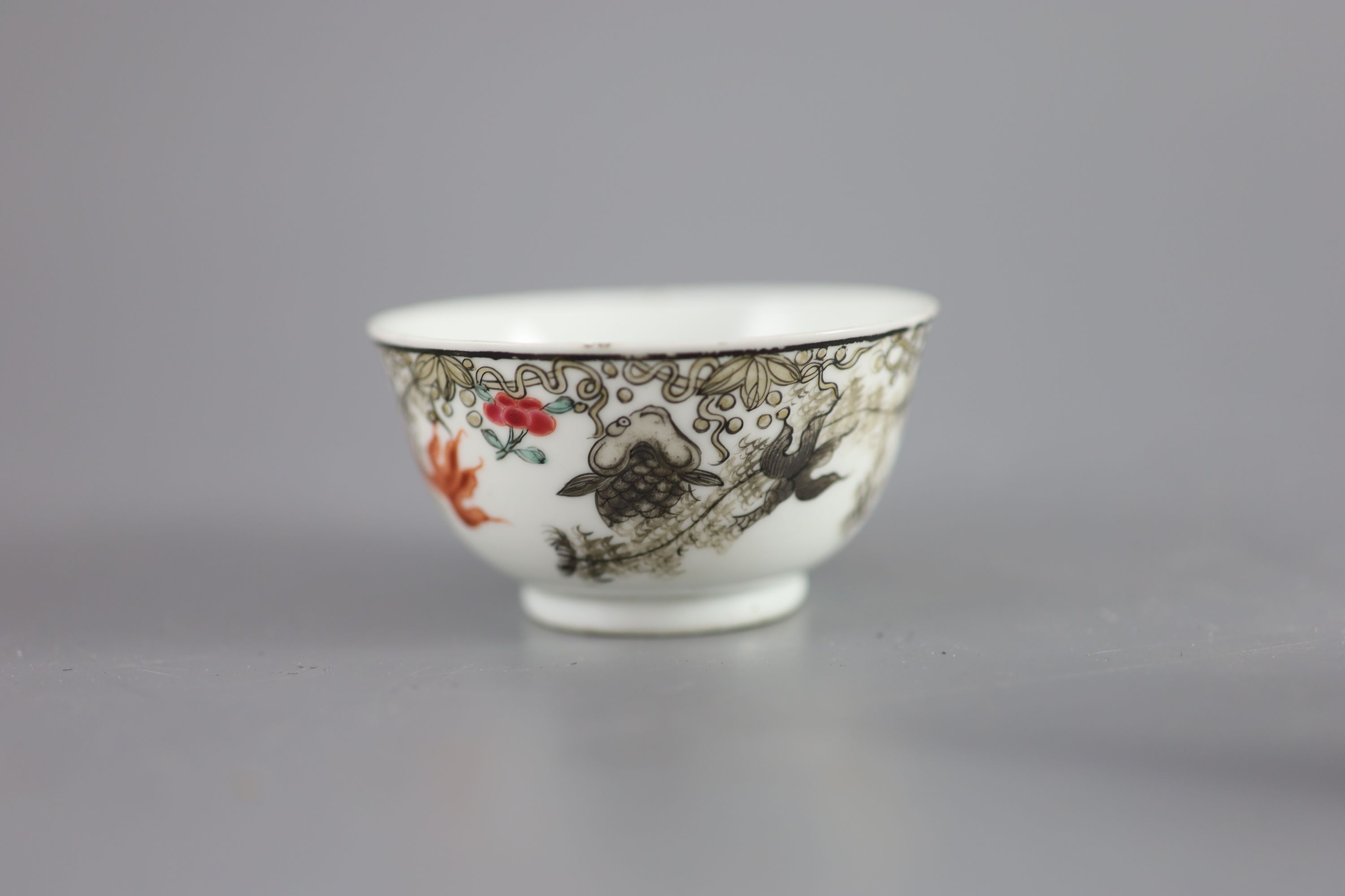 A Chinese Qianlong tea bowl decorated with goldfish, and an associated saucer, diameter 7.5cm and 10.5cm